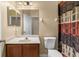 Well-lit bathroom with modern fixtures, a toilet, and a vanity with storage at 4027 Sunrise Ridge Blvd, Groveland, FL 34736