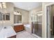 Bathroom featuring double sinks, a soaking tub, and a glass-enclosed shower at 4027 Sunrise Ridge Blvd, Groveland, FL 34736