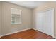 Bedroom featuring hardwood floors, neutral paint, a window, and closet at 4027 Sunrise Ridge Blvd, Groveland, FL 34736