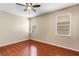 Well-lit bedroom featuring neutral walls, two windows, and a ceiling fan at 4027 Sunrise Ridge Blvd, Groveland, FL 34736