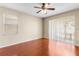 Cozy bedroom featuring neutral walls, a ceiling fan, and a sliding glass door allowing lots of natural light at 4027 Sunrise Ridge Blvd, Groveland, FL 34736