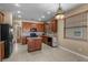 Spacious kitchen featuring stainless steel appliances, granite countertops, tile floors, and wooden cabinetry at 4027 Sunrise Ridge Blvd, Groveland, FL 34736