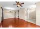 Open concept living room featuring hardwood floors, neutral walls, recessed lighting, and archways to other rooms at 4027 Sunrise Ridge Blvd, Groveland, FL 34736