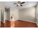 Spacious main bedroom featuring neutral walls, a ceiling fan, and an ensuite bathroom with a soaking tub at 4027 Sunrise Ridge Blvd, Groveland, FL 34736