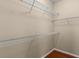 Spacious walk-in closet with ample shelving for organization at 4027 Sunrise Ridge Blvd, Groveland, FL 34736