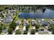 Wide aerial view showing a home, its neighborhood, a pond, and surrounding trees at 4060 Longworth Loop, Kissimmee, FL 34744