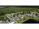 Aerial view showcasing the house nestled within a neighborhood with serene pond views and green spaces at 4060 Longworth Loop, Kissimmee, FL 34744