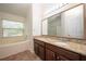 Bathroom featuring a soaking tub, shower, and a dual vanity with granite countertops at 4060 Longworth Loop, Kissimmee, FL 34744