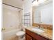 Bright bathroom featuring a tub with shower, granite countertop, and tile flooring at 4060 Longworth Loop, Kissimmee, FL 34744