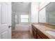 Well-lit bathroom with a soaking tub, shower, and dual vanities with granite countertops at 4060 Longworth Loop, Kissimmee, FL 34744