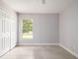 Bedroom featuring a window, tiled floor, and a double door closet at 4060 Longworth Loop, Kissimmee, FL 34744