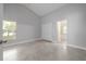 Spacious bedroom with neutral paint, tiled floor, high ceilings, and a view of the backyard at 4060 Longworth Loop, Kissimmee, FL 34744