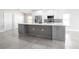 Modern kitchen island with gray cabinets, white countertop, and stainless steel appliances in an open-concept design at 4060 Longworth Loop, Kissimmee, FL 34744