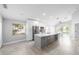 Bright, open kitchen with a large island, white cabinets, stainless steel appliances, and tile flooring at 4060 Longworth Loop, Kissimmee, FL 34744