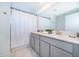 Well-lit bathroom with double sinks and shower with white curtain at 4220 Paragraph Dr, Kissimmee, FL 34746