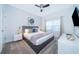 Comfortable bedroom with gray king bed, ceiling fan, and a window at 4220 Paragraph Dr, Kissimmee, FL 34746