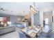 Open-concept living area featuring a modern kitchen, dining table and comfortable seating at 4220 Paragraph Dr, Kissimmee, FL 34746