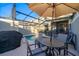 Backyard with outdoor dining and an umbrella by the pool at 4220 Paragraph Dr, Kissimmee, FL 34746