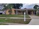 Charming single-story home featuring a covered entrance, carport and well-maintained lawn at 4619 Salvia Dr, Orlando, FL 32839