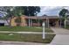 Charming single-story home featuring a covered entrance, carport and well-maintained lawn at 4619 Salvia Dr, Orlando, FL 32839