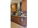 Functional kitchen featuring wood cabinets, stainless hood, and modern backsplash at 4619 Salvia Dr, Orlando, FL 32839