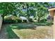 A fenced-in backyard features mature shade trees and grass at 466 Drexel Ridge Cir, Ocoee, FL 34761