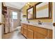 Bathroom boasts a double sink vanity, framed mirrors, and tiled shower with patterned curtains at 466 Drexel Ridge Cir, Ocoee, FL 34761