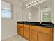 Bathroom featuring dual sinks, natural light, and light wood cabinetry at 466 Drexel Ridge Cir, Ocoee, FL 34761