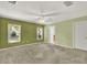 Spacious bedroom with carpet flooring, ceiling fan, and natural light from windows at 466 Drexel Ridge Cir, Ocoee, FL 34761
