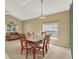 This bright dining room features a chandelier, a large window and a comfortable couch at 466 Drexel Ridge Cir, Ocoee, FL 34761