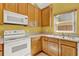 Functional kitchen featuring a stove, microwave, a window and ample counter space at 466 Drexel Ridge Cir, Ocoee, FL 34761