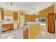Bright kitchen featuring tile floors, a breakfast bar, and a view to the backyard at 466 Drexel Ridge Cir, Ocoee, FL 34761