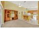 Open-concept living room highlighting kitchen with breakfast bar and built-in entertainment center at 466 Drexel Ridge Cir, Ocoee, FL 34761