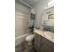 Bathroom with combination tub and shower with gray vanity and coordinated beach decor at 4800 S Semoran Blvd # 101, Orlando, FL 32822