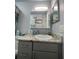 Bathroom features a granite vanity, mirror and modern fixtures, offering a clean and functional design at 4800 S Semoran Blvd # 101, Orlando, FL 32822