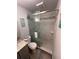 Bathroom with granite countertops, gray cabinets, and tiled walk-in shower with glass door at 4800 S Semoran Blvd # 101, Orlando, FL 32822