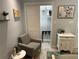 Cozy bedroom featuring a comfortable chair and a glimpse into the walk-in closet at 4800 S Semoran Blvd # 101, Orlando, FL 32822