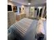 Serene bedroom showcasing a bed, dresser, TV, ensuite bathroom, and walk-in closet at 4800 S Semoran Blvd # 101, Orlando, FL 32822