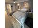 Bedroom featuring en suite bath, stylish furnishings, and modern decor at 4800 S Semoran Blvd # 101, Orlando, FL 32822