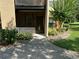 Building exterior featuring lush landscaping and covered entryway, creating an inviting approach at 4800 S Semoran Blvd # 101, Orlando, FL 32822