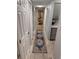 Inviting hallway featuring a decorative rug, leading to a bedroom and adjacent to kitchen space at 4800 S Semoran Blvd # 101, Orlando, FL 32822