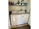 Practical laundry area featuring a standard washer and dryer, with storage shelf for supplies at 4800 S Semoran Blvd # 101, Orlando, FL 32822