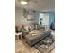 Inviting living room featuring a comfortable gray sectional couch and stylish decor on tile flooring at 4800 S Semoran Blvd # 101, Orlando, FL 32822