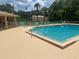 Community swimming pool with ample lounge chairs and a covered patio area at 4800 S Semoran Blvd # 101, Orlando, FL 32822