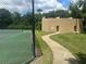 Exterior view of private tennis courts and clubhouse, connected with paved path at 4800 S Semoran Blvd # 101, Orlando, FL 32822
