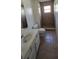 Tiled bathroom featuring shower with window, toilet, and vanity sink with cabinets at 4906 Gifford Blvd, Orlando, FL 32821