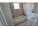 A well-lit bathroom with a bathtub and shower combo, tiled walls, and a functional vanity at 4906 Gifford Blvd, Orlando, FL 32821