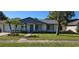 Charming single-story home with manicured lawn, garden beds, and a walkway leading to the front door at 4906 Gifford Blvd, Orlando, FL 32821