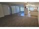 Open-concept living area featuring carpet and tile flooring, with easy access to the kitchen at 4906 Gifford Blvd, Orlando, FL 32821