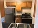 Functional kitchen with stainless steel appliances, light wood cabinets, and dark countertops at 530 Ruffel St, Maitland, FL 32751